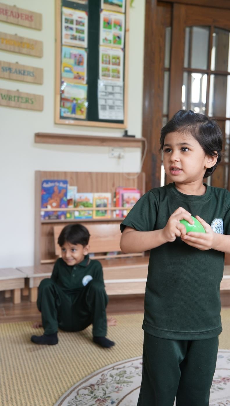 A pupil standing confidently with arms folded
