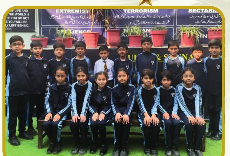 Primary school students seated for a group photograph