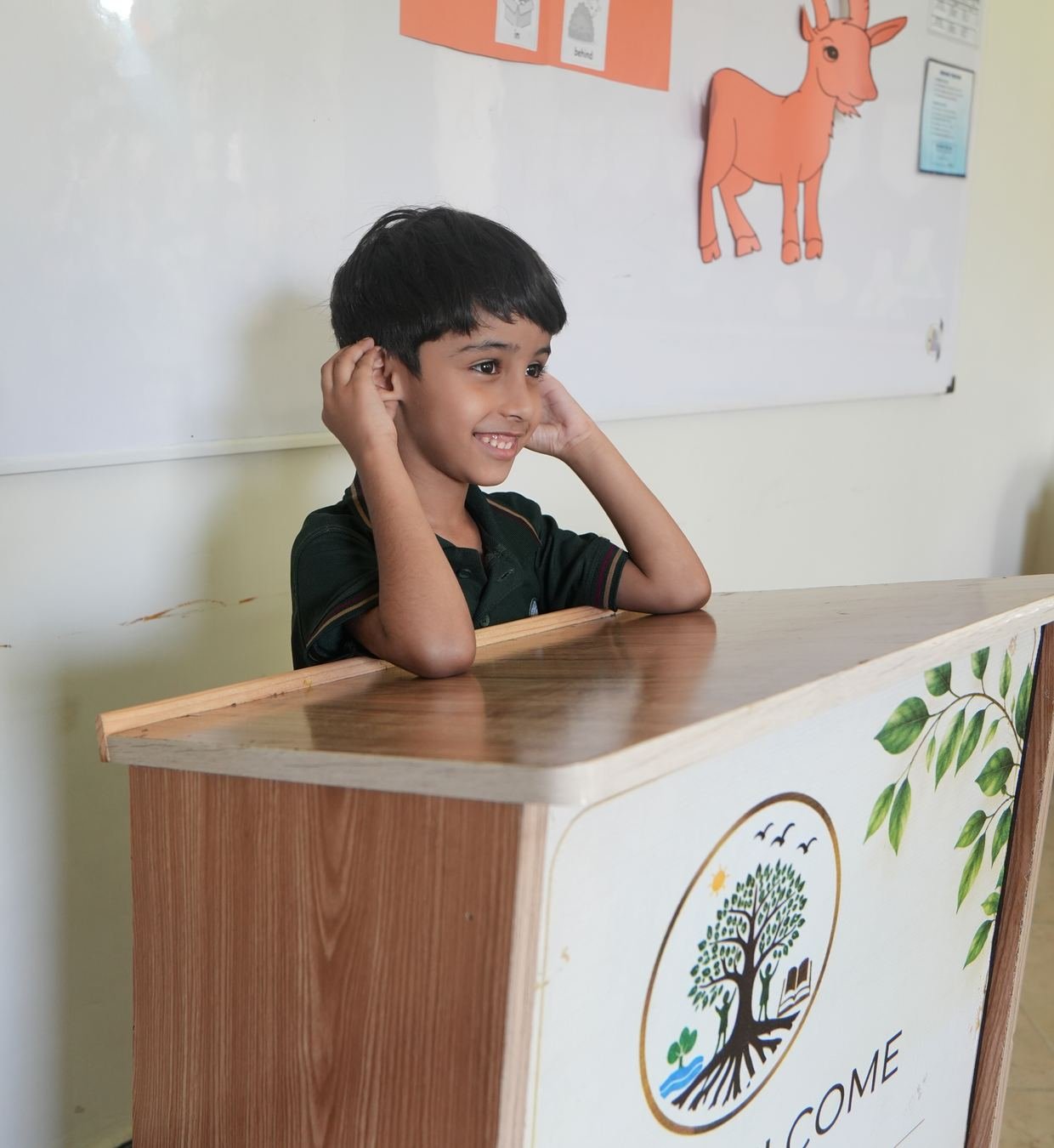 A pupil standing proudly by a wall of affirmations