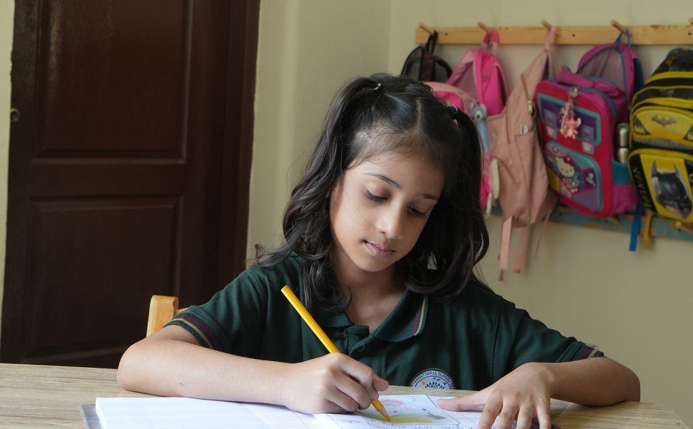 Pupils reading the Quran on rehal stands