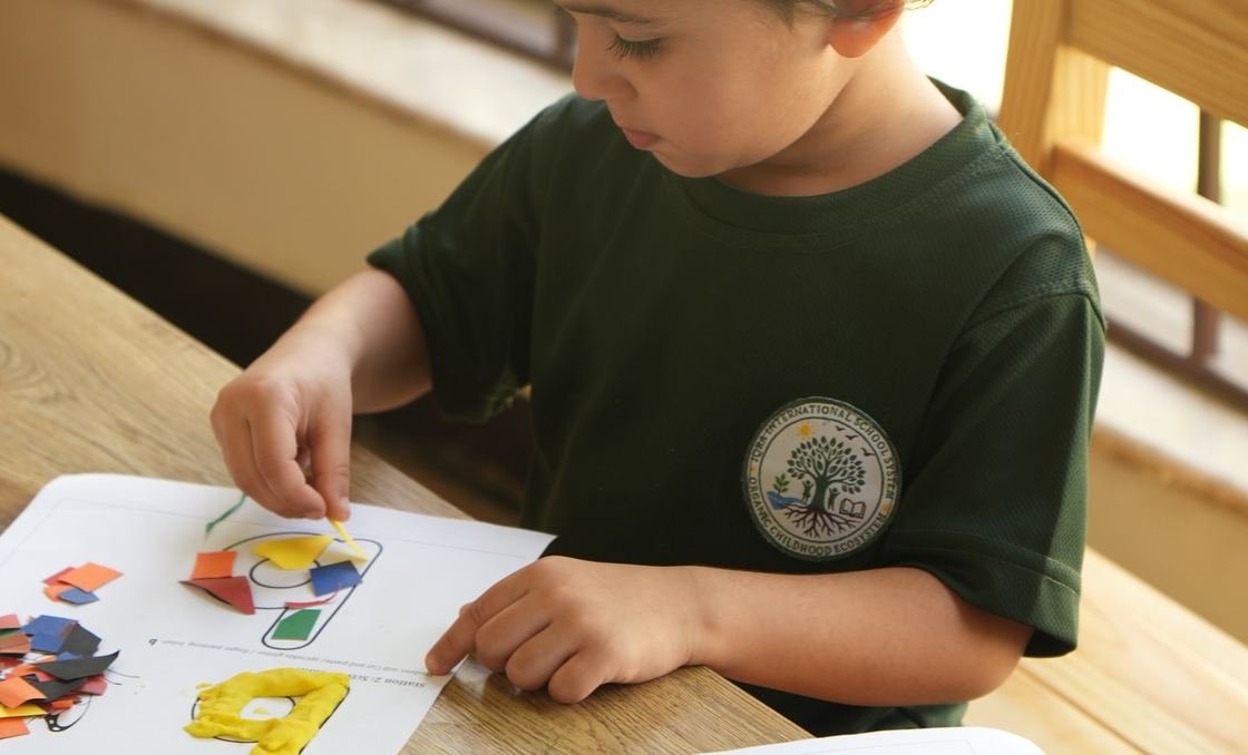 Pupils painting at a shared table