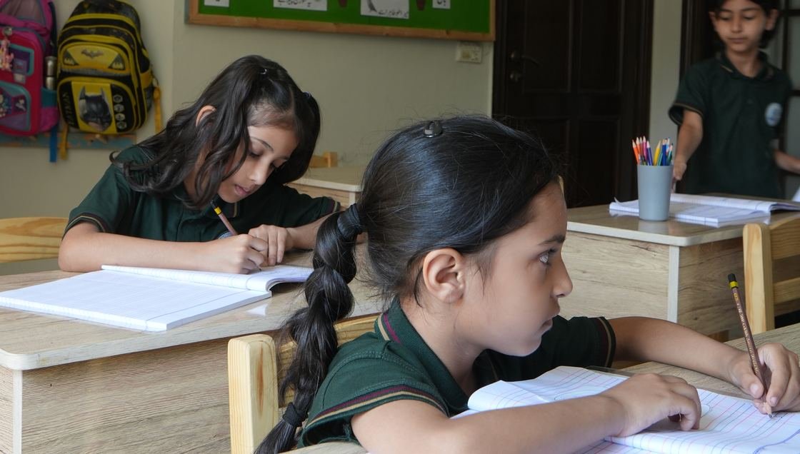 Pupils reading together in the library