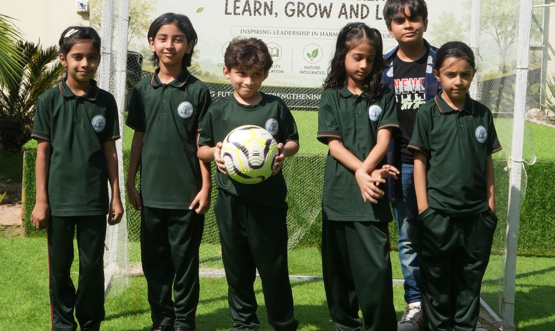 Pupils playing football on the school field
